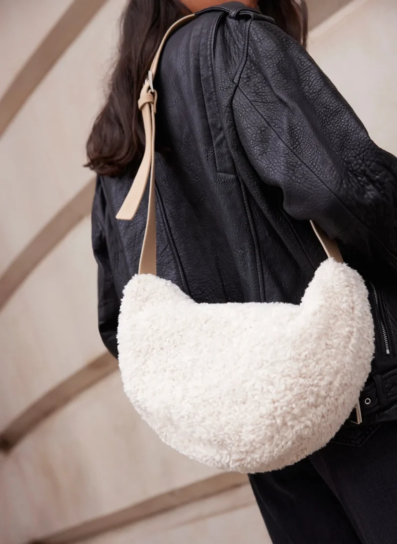 textured borg sling bag in cream